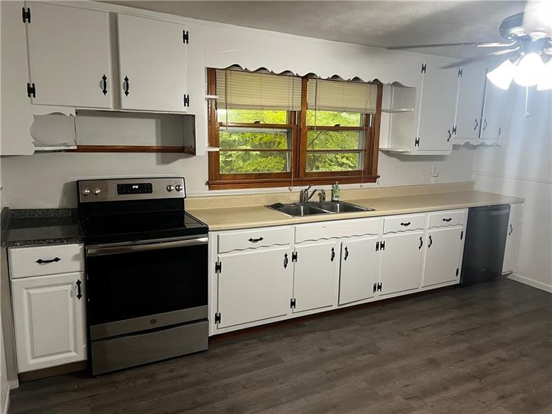 3743 Jiles Road Kennesaw, GA 30144 - Photo 8 of 21 a kitchen with a sink stove and cabinets