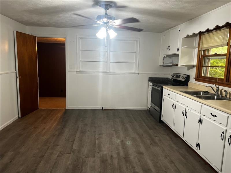 3743 Jiles Road Kennesaw, GA 30144 - Photo 10 of 21 a kitchen with granite countertop a stove a sink and a refrigerator