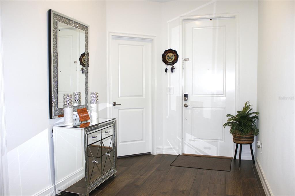 18331 Serene Lk Loop Lutz, FL 33548 - Photo 12 of 46 a view of a hallway with entryway wooden floor and front door