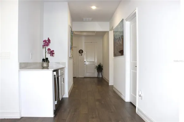 a view of a hallway with a dining table