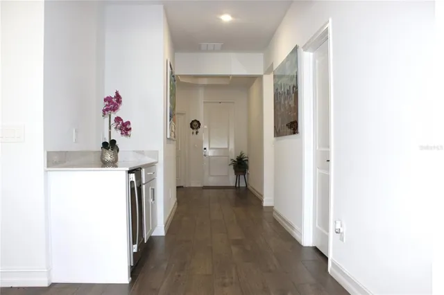a view of a hallway with a dining table