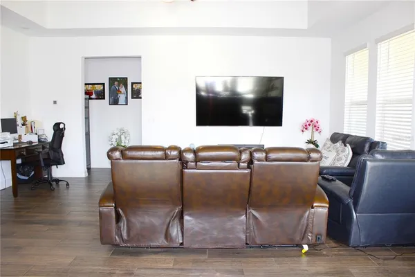 a living room with furniture and a flat screen tv