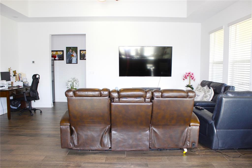 18331 Serene Lk Loop Lutz, FL 33548 - Photo 24 of 46 a living room with furniture and a flat screen tv