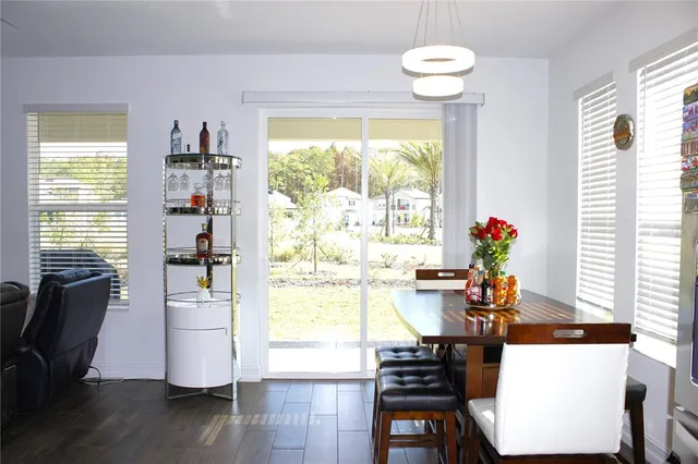 a view of a dining room with furniture and a large window