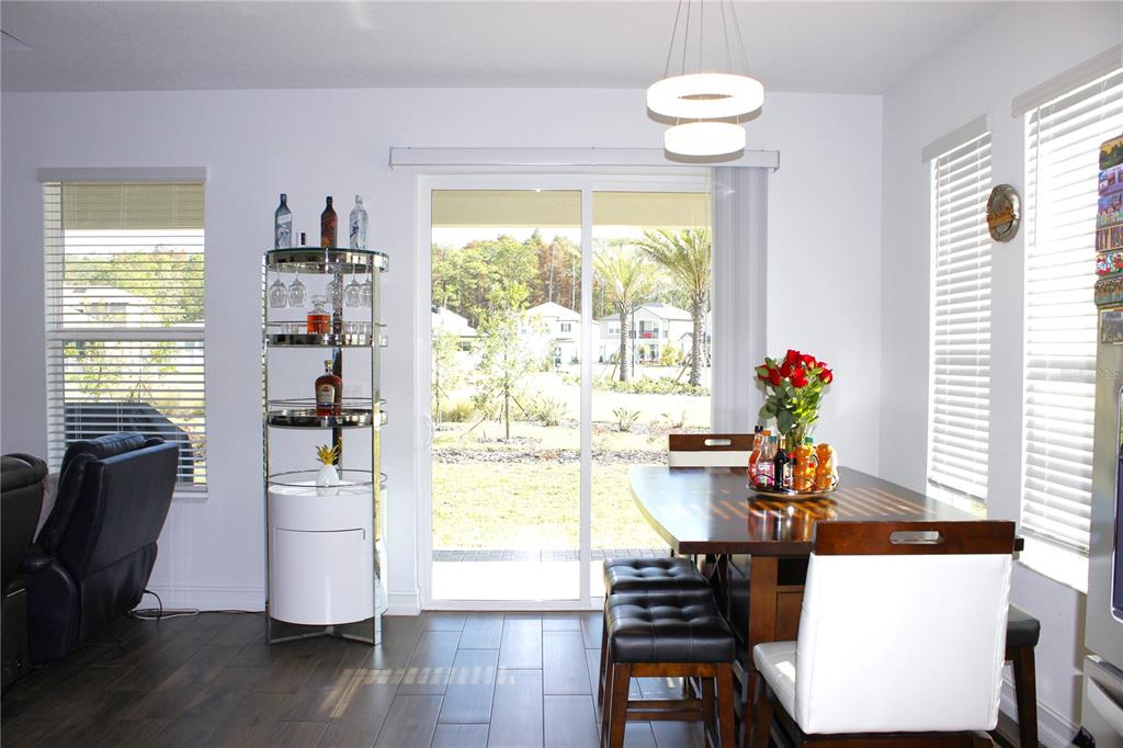 18331 Serene Lk Loop Lutz, FL 33548 - Photo 26 of 46 a view of a dining room with furniture and a large window