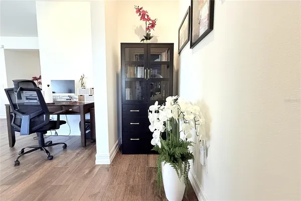 a view of a workspace with furniture and a potted plant