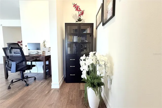 a view of a workspace with furniture and a potted plant