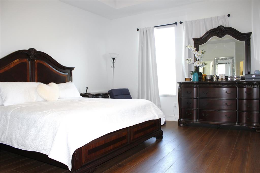 18331 Serene Lk Loop Lutz, FL 33548 - Photo 28 of 46 a bedroom with a bed and wooden floor