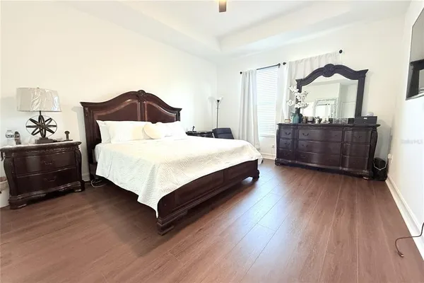 a bedroom with a bed lamp and a dresser