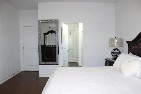 a bedroom with a bed and a mirror