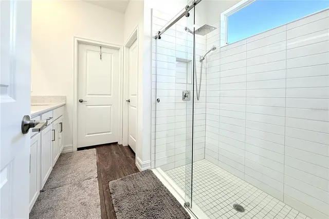 a bathroom with a shower and a sink