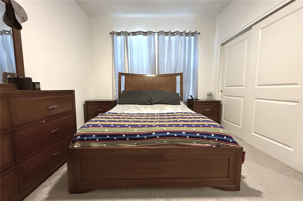 18331 Serene Lk Loop Lutz, FL 33548 - Photo 35 of 46 a bedroom with a bed and a window