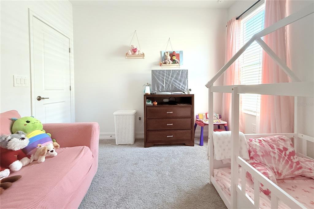 18331 Serene Lk Loop Lutz, FL 33548 - Photo 43 of 46 a bedroom with a bed and wooden floor