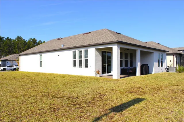 a view of an house with pool and garden