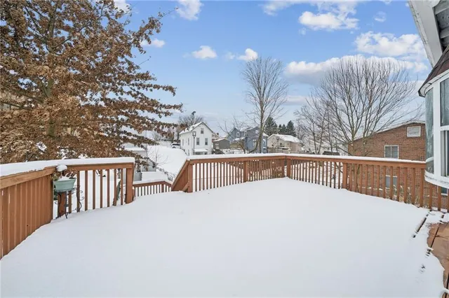 a view of a house with pool and wooden fence