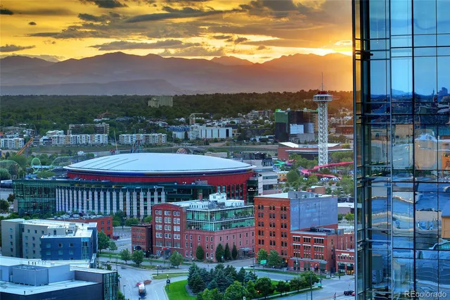 a view of kitchen with stainless steel appliances wooden floor and window