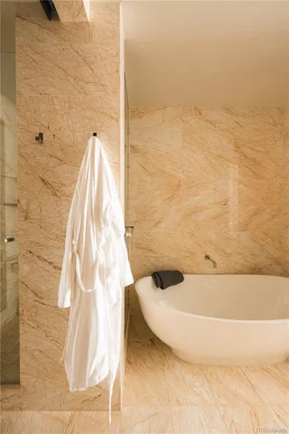 a bedroom with a large bed and a large window