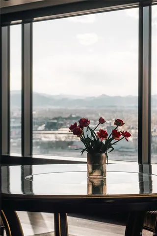 a dining room with furniture a chandelier and wooden floor