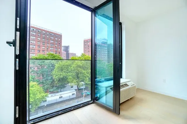 a view of a room with a large window and a balcony