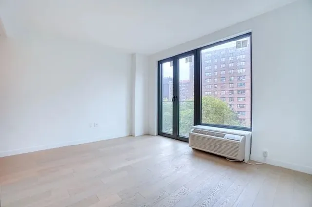a view of room with couch and floor to ceiling window