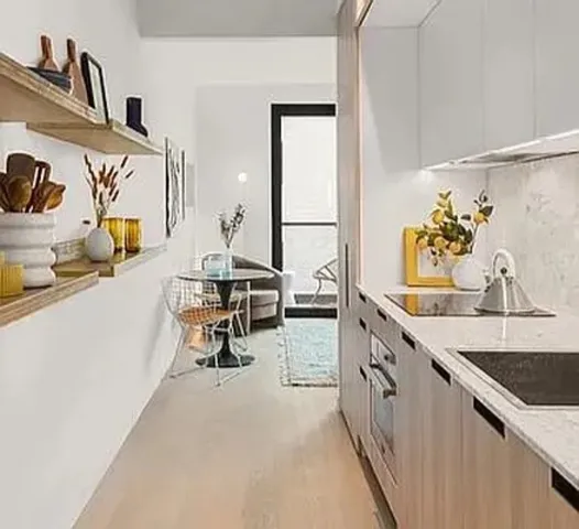 a view of a kitchen with stainless steel appliances granite countertop furniture