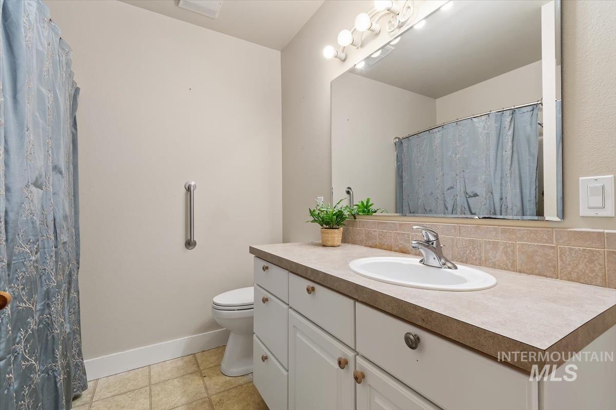 10462 West Lanktree Gulch Road Star, ID 83669 - Photo 33 of 48 Bathroom vanity with an integrated sink, polished chrome faucet, and ample under-sink storage