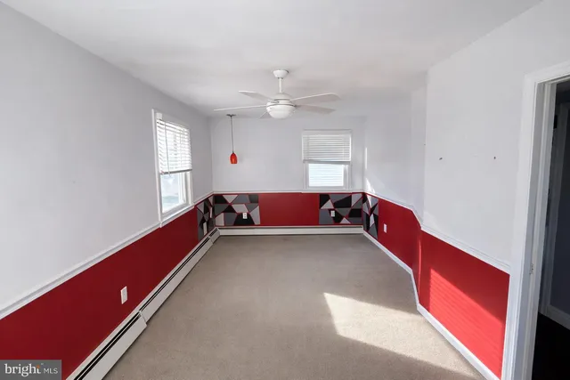 a living room with furniture pool table and a window