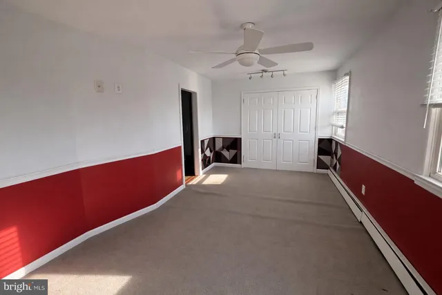 a view of room with a ceiling fan