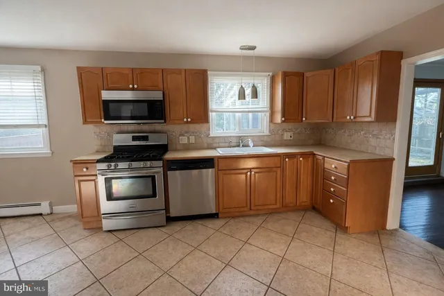 a kitchen with a stove sink and microwave