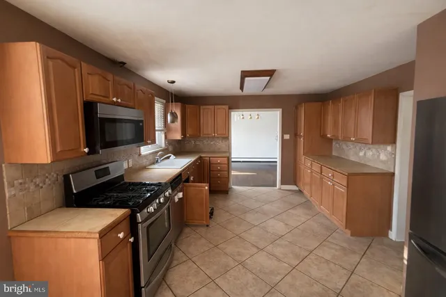 a kitchen with a stove a sink and a refrigerator