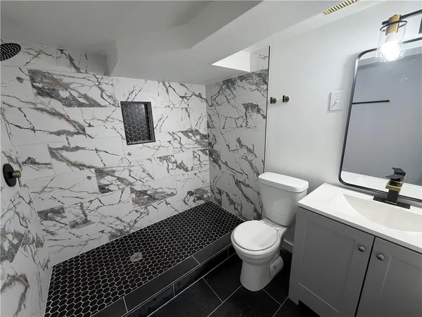 a bathroom with a toilet and a shower