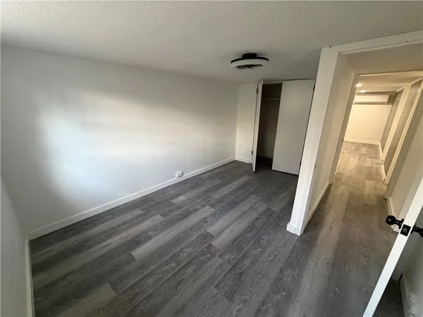 an empty room with wooden floor and a window