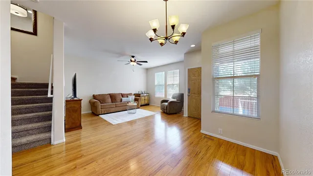 a living room with furniture and wooden floor