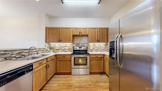 a kitchen with a stove sink and refrigerator