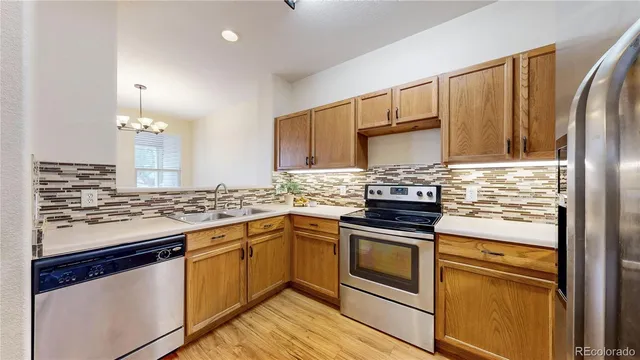 a kitchen with stainless steel appliances granite countertop a stove and a refrigerator