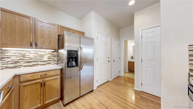 a kitchen with stainless steel appliances granite countertop a refrigerator and a stove