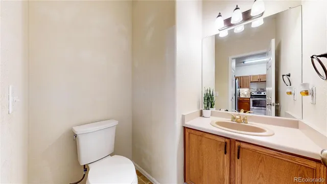 a bathroom with a sink vanity mirror and toilet