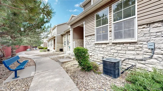 a view of a house with backyard and sitting area