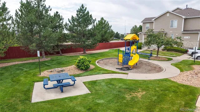 a view of a park with chairs and a fire pit