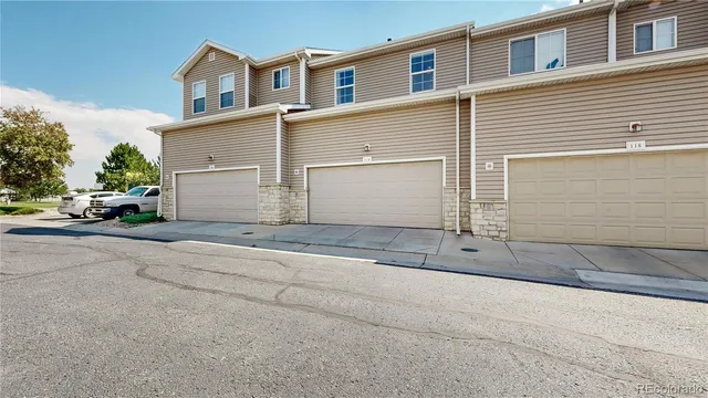 a view of garage with a yard