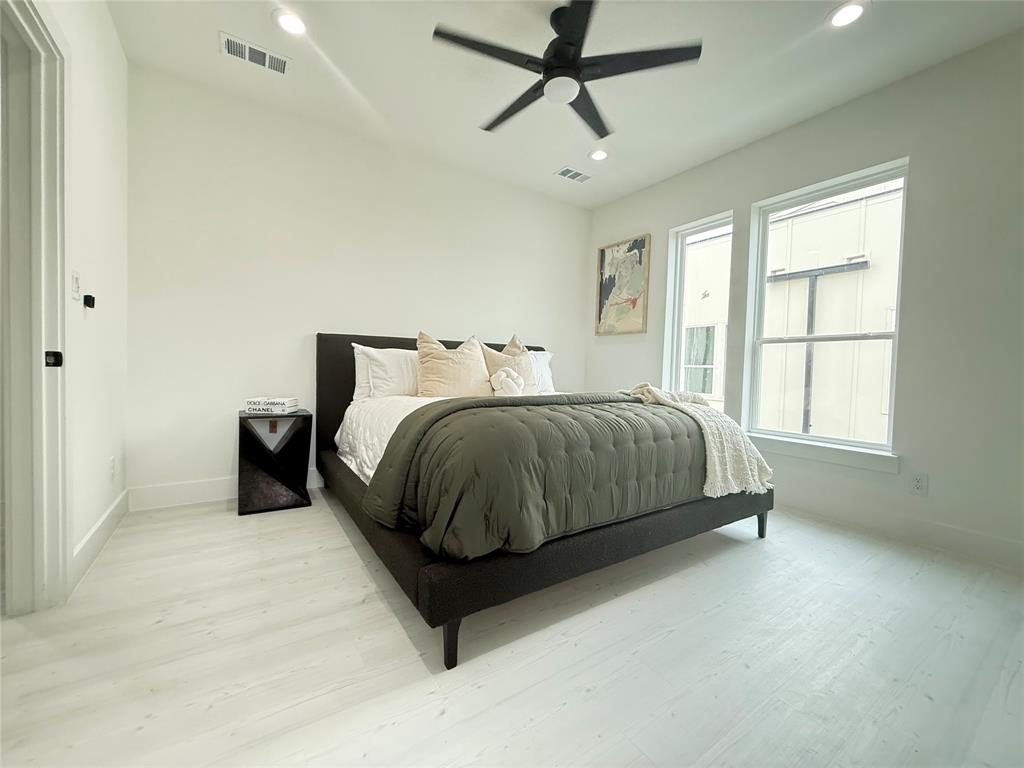 7207 Mohawk Drive, Unit 303 Dallas, TX 75235 - Photo 13 of 23 a bedroom with a bed and window