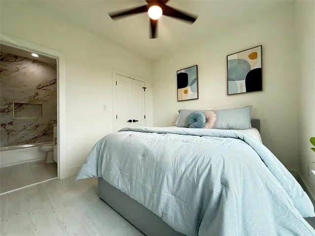 a bedroom with a bed and painting on the wall