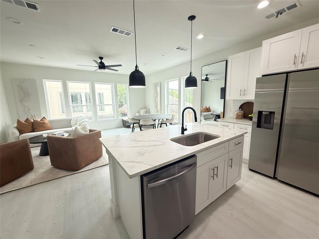 7207 Mohawk Drive, Unit 303 Dallas, TX 75235 - Photo 19 of 23 a kitchen with counter top space sink stove and refrigerator
