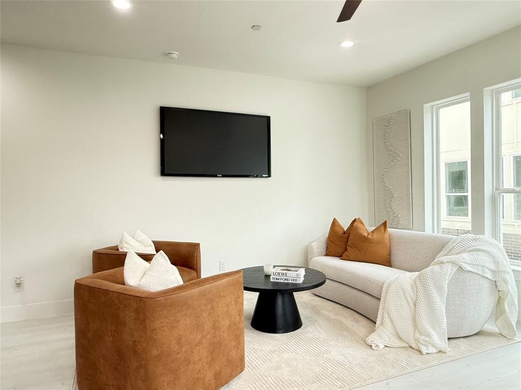7207 Mohawk Drive, Unit 303 Dallas, TX 75235 - Photo 5 of 23 a living room with furniture and a flat screen tv