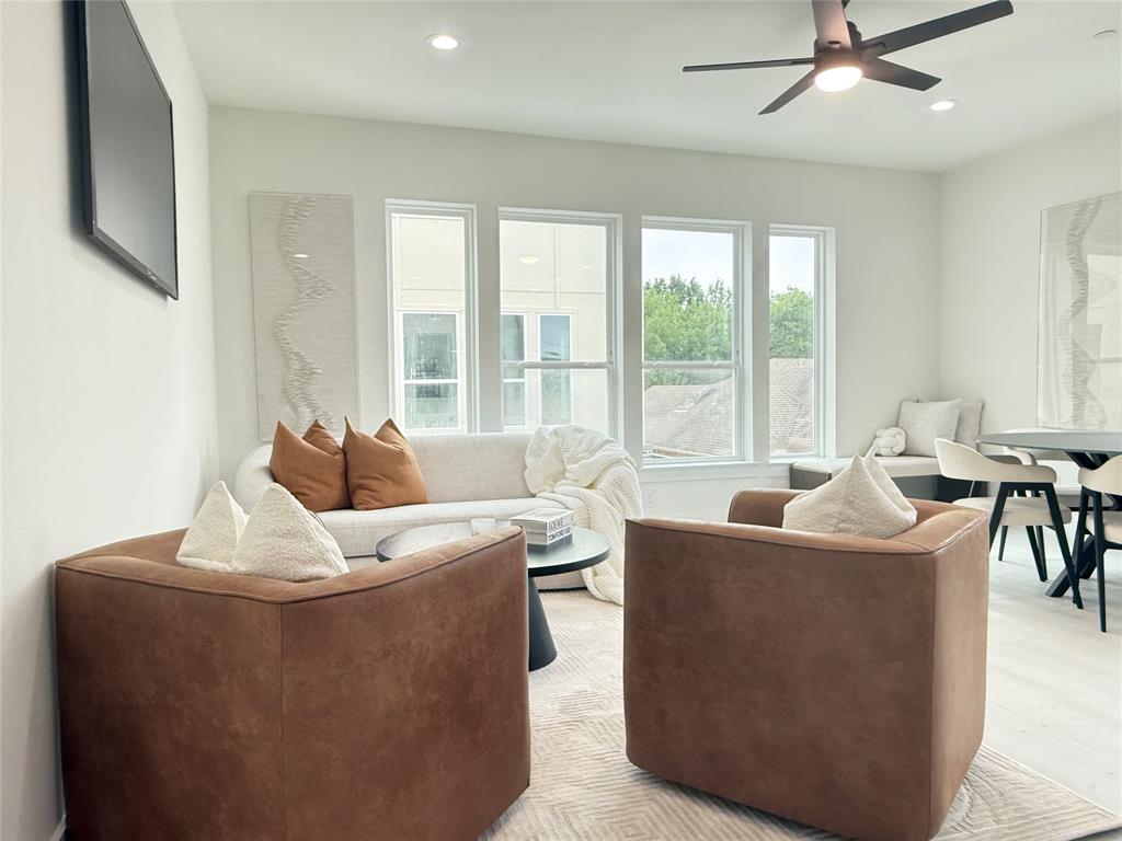 7207 Mohawk Drive, Unit 303 Dallas, TX 75235 - Photo 6 of 23 a living room with furniture and a large window