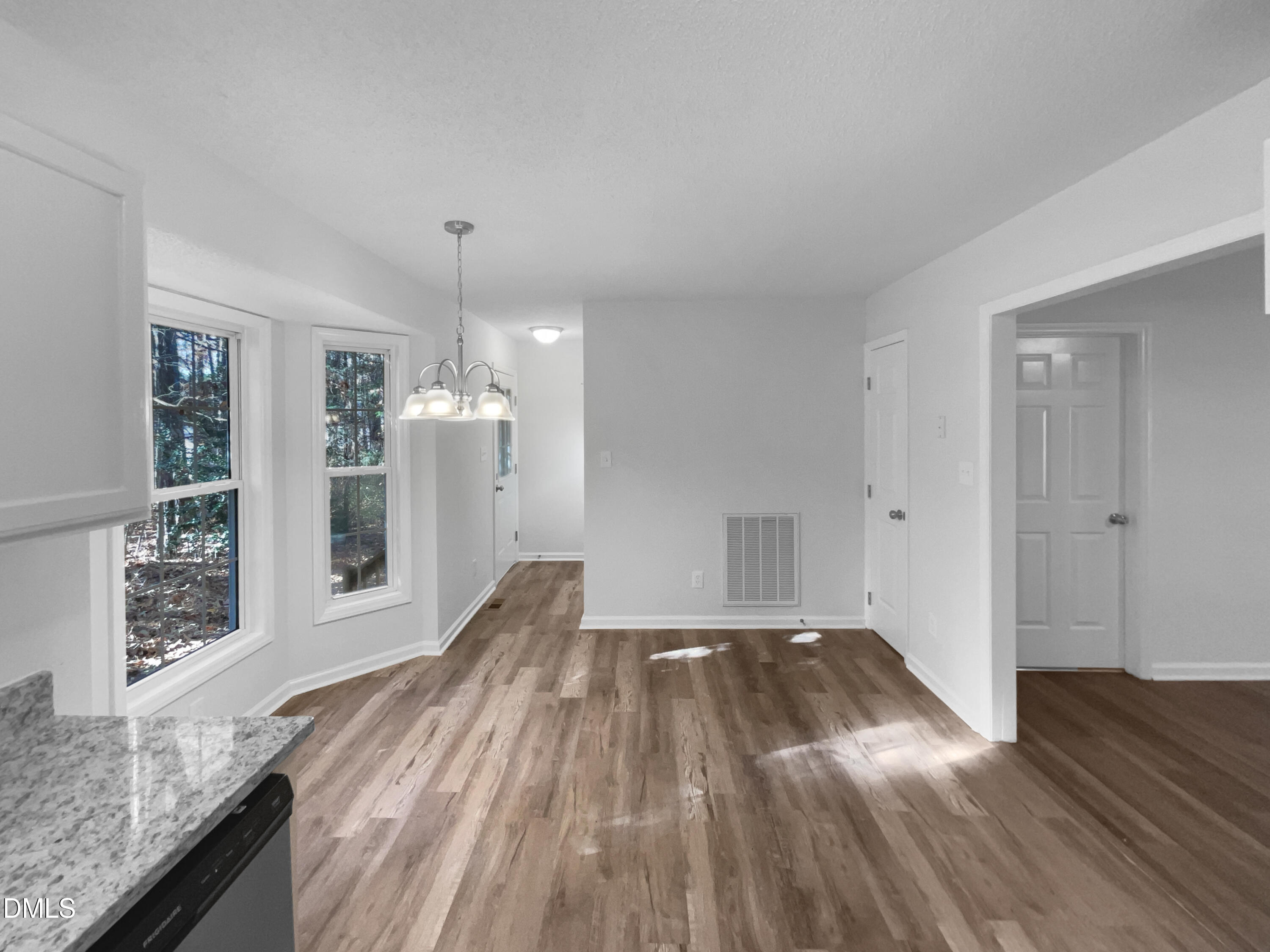 5901 Presentation Street Knightdale, NC 27545 - Photo 7 of 16 a view of a livingroom with wooden floor and a kitchen space