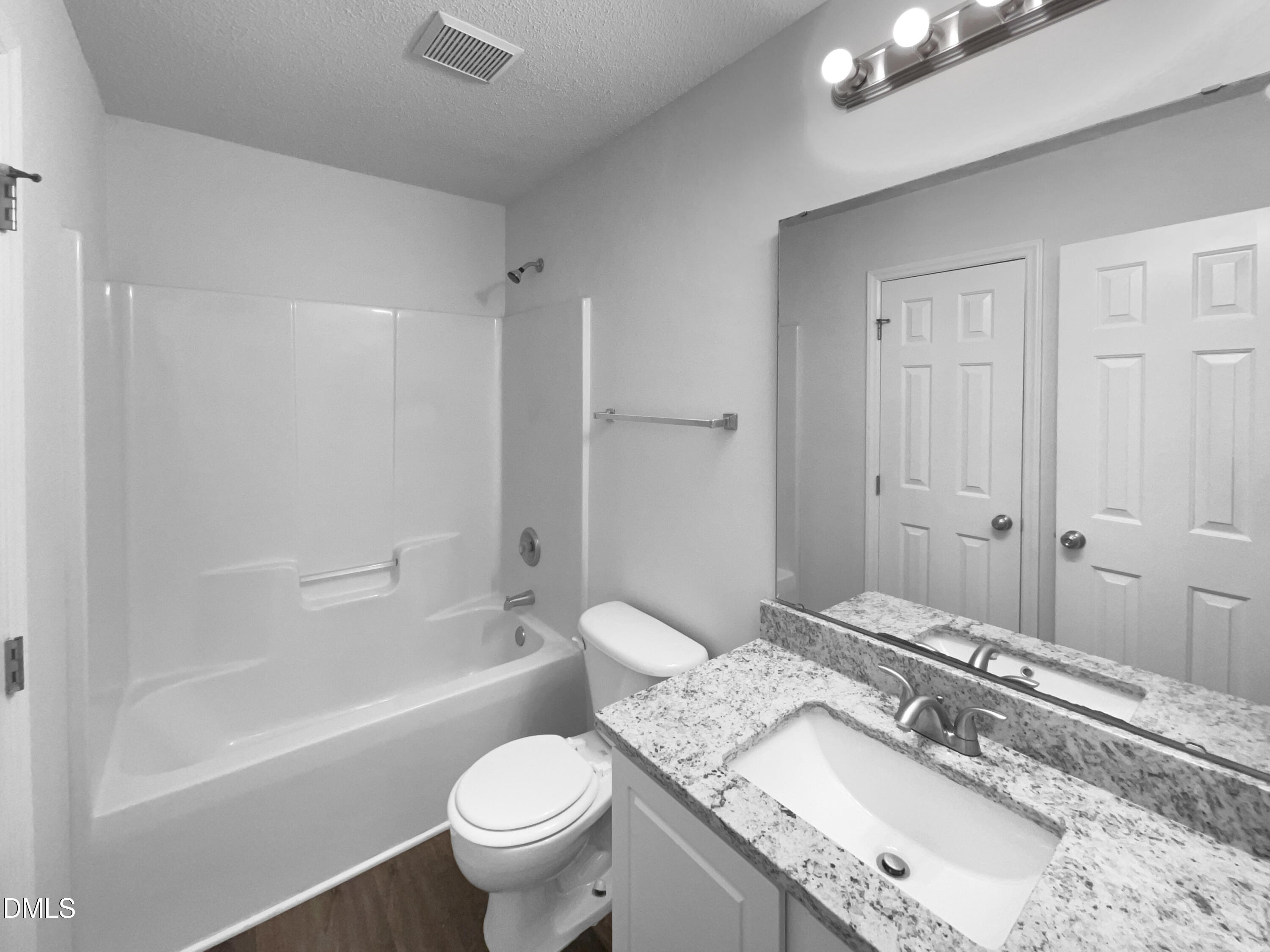 5901 Presentation Street Knightdale, NC 27545 - Photo 10 of 16 a bathroom with a granite countertop sink a toilet and bathtub
