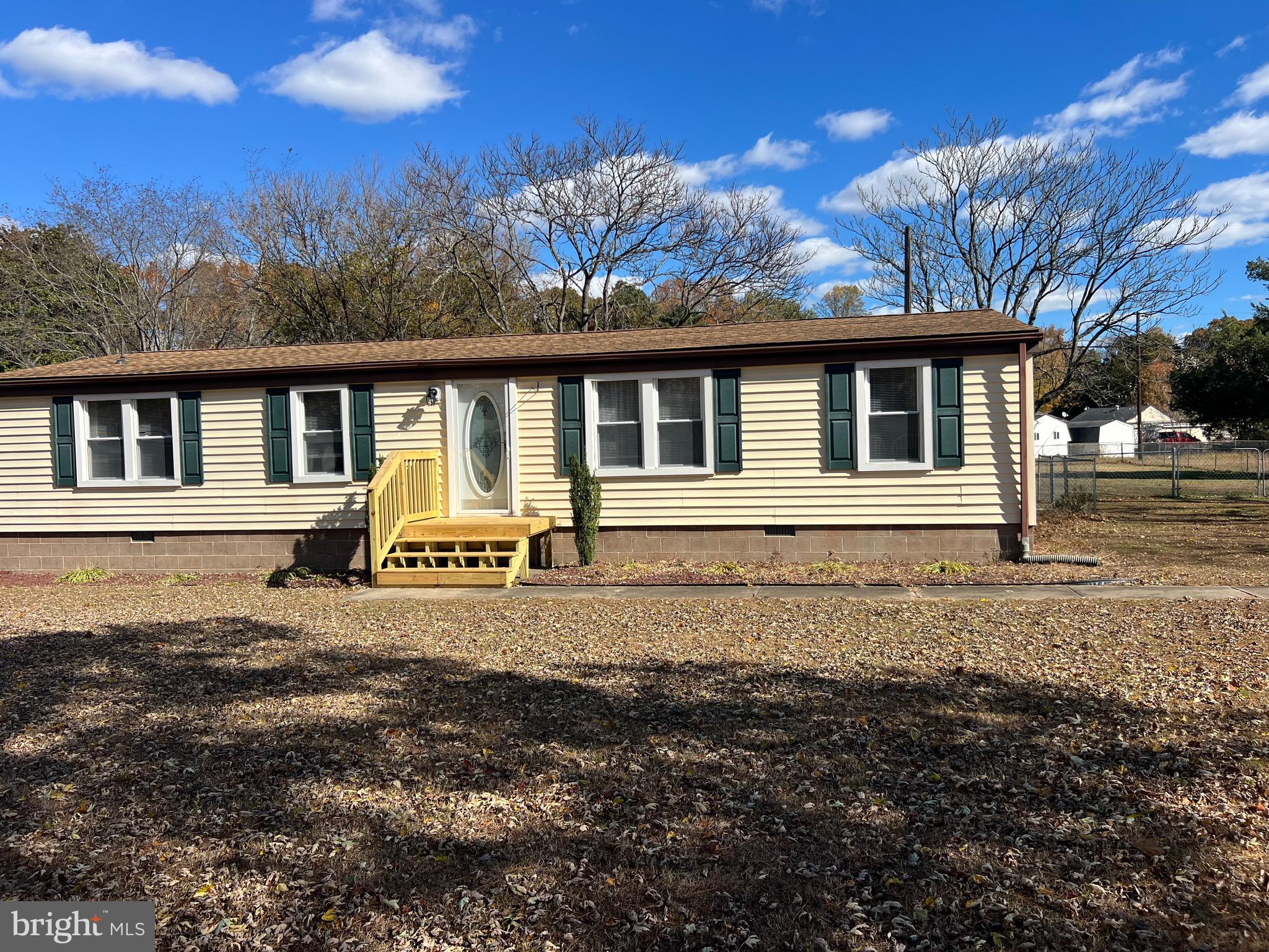 a view of a white house with a yard