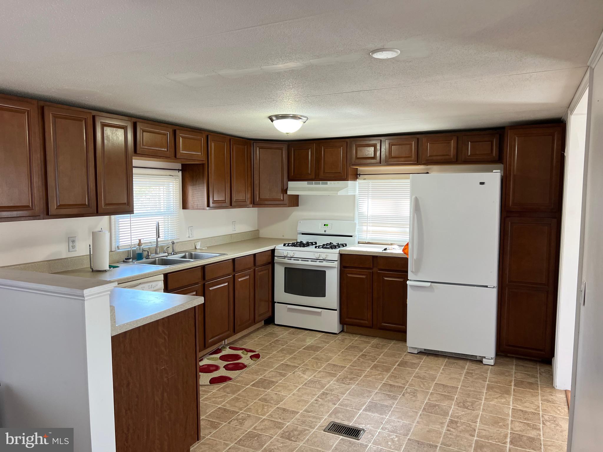 150 West Street Magnolia, DE 19962 - Photo 3 of 23 a kitchen with stainless steel appliances granite countertop a refrigerator sink and cabinets