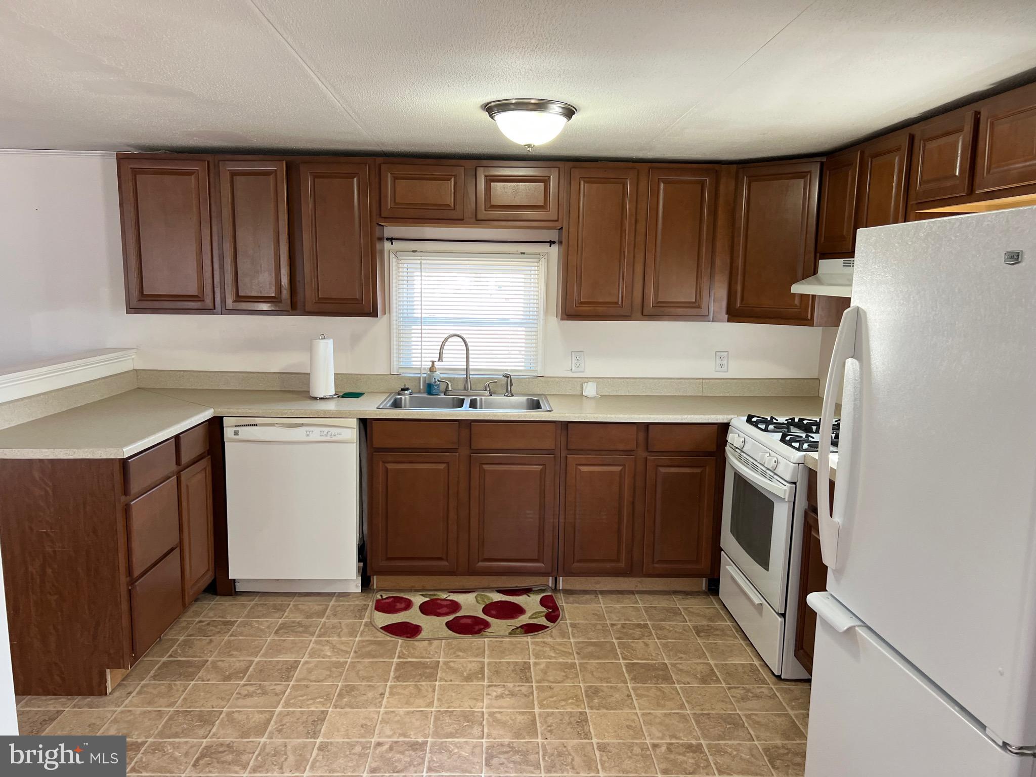 150 West Street Magnolia, DE 19962 - Photo 5 of 23 a kitchen with a sink a stove a refrigerator and cabinetry
